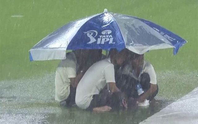 IPL 2023: Ground staff at Narendra Modi takes shelter under umbrella as heavy downpour stalls play